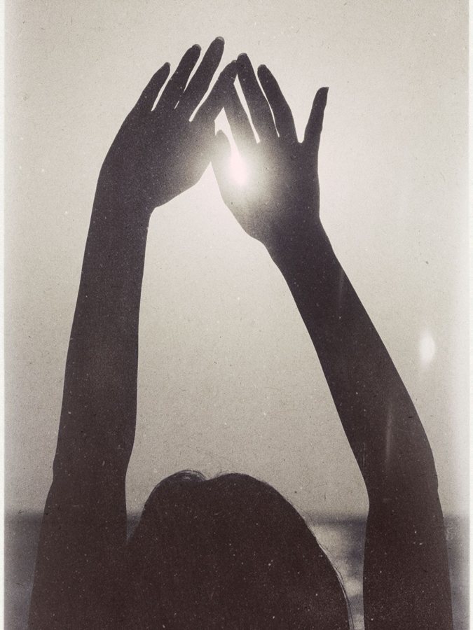 Hands raised toward the sun