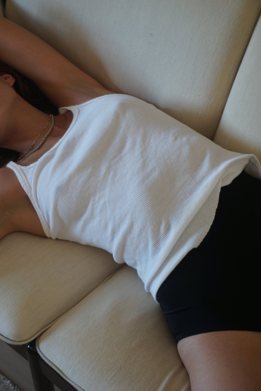 Lying on a cream sofa